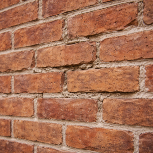 Close-up of deteriorated mortar joints on a Toronto brick wall