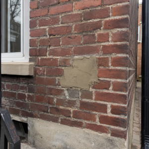 Older Toronto brickwork with cracked mortar and poor patch repair.