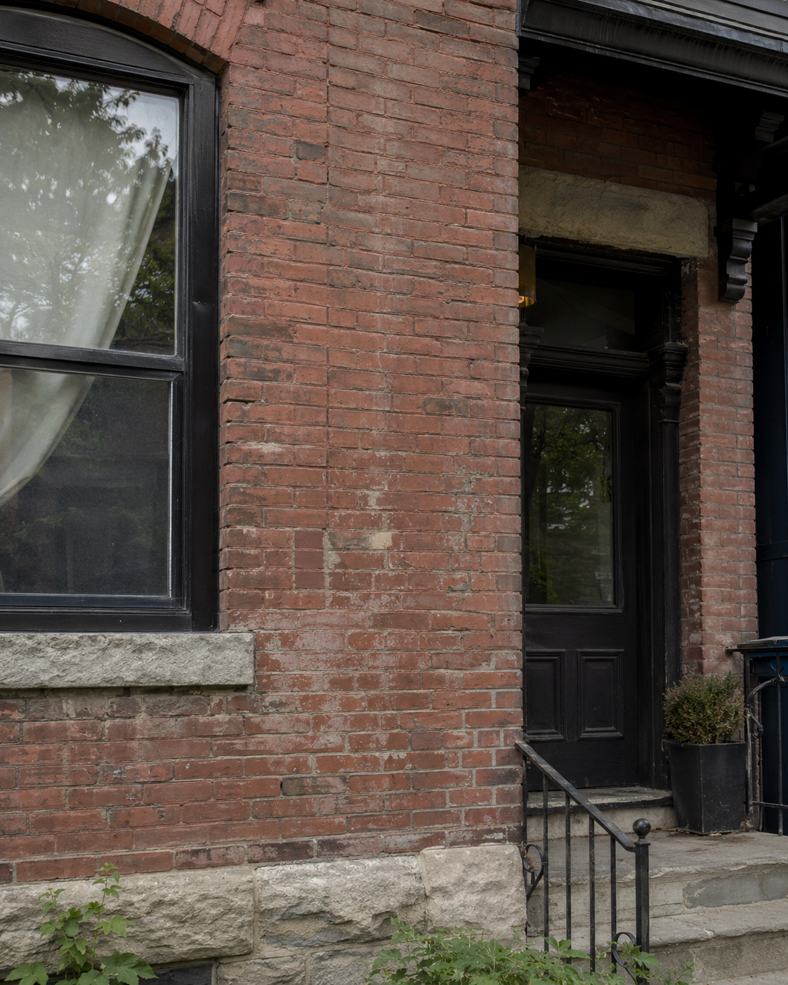 Older brick exterior losing its original character due to age, wear, and previous repairs