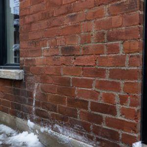 Older Toronto brickwork showing winter wear and mortar damage.