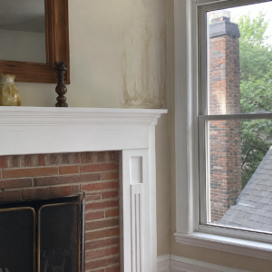 Interior water staining near a chimney caused by moisture entry.