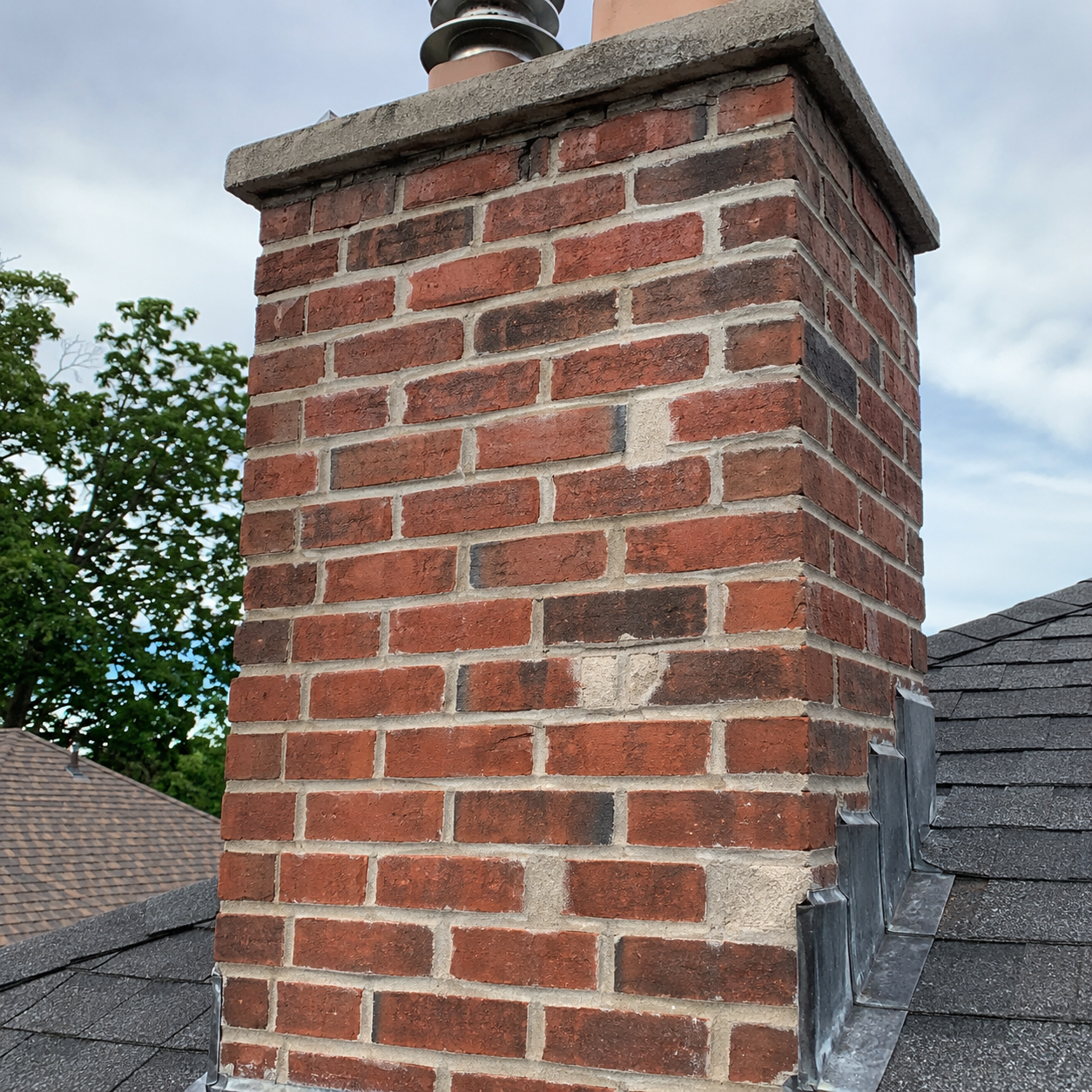Chimney tuckpointing and mortar repair on a Toronto brick chimney