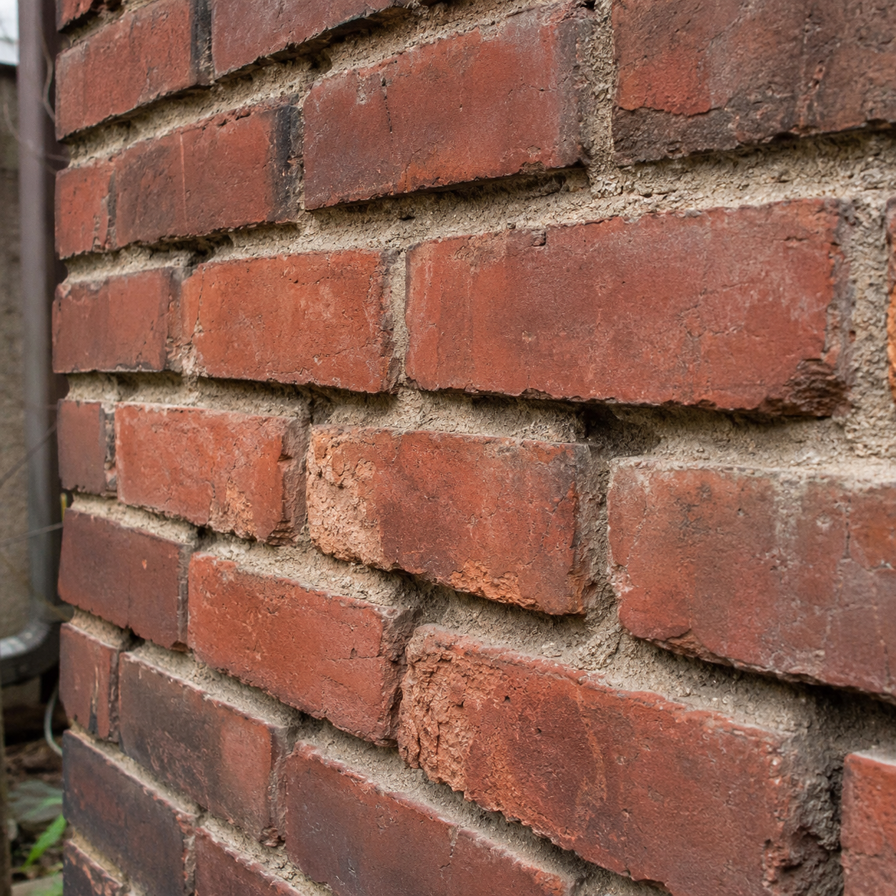 Mortar washed out by weather exposure on brickwork